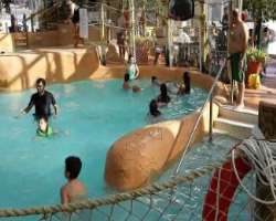 A park is a place full of enjoyment with a giant tipping bucket, high water slides, wave pool, and kiddie pool alongside a retractable glass roof that